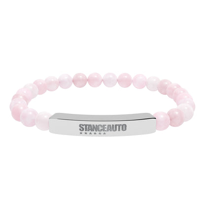 Bracelet Stance Auto Engraved Natural Stone Stretch Bar Bracelet with pink stone beads and a polished metal bar.